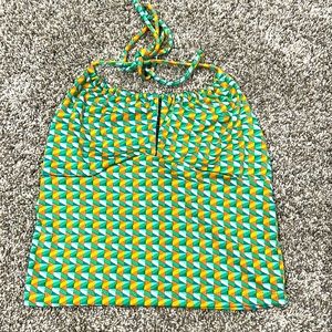 Patterned crop top with, half open back, and string tie around back of neck.